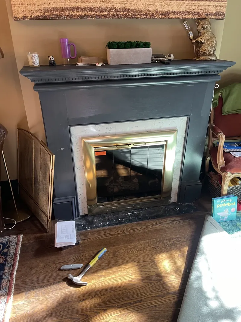 Gas fireplace insert in a painted fireplace surround