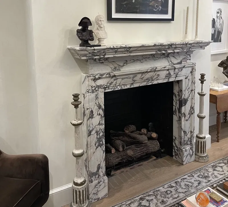 Marble fireplace with gas logs in an apartment