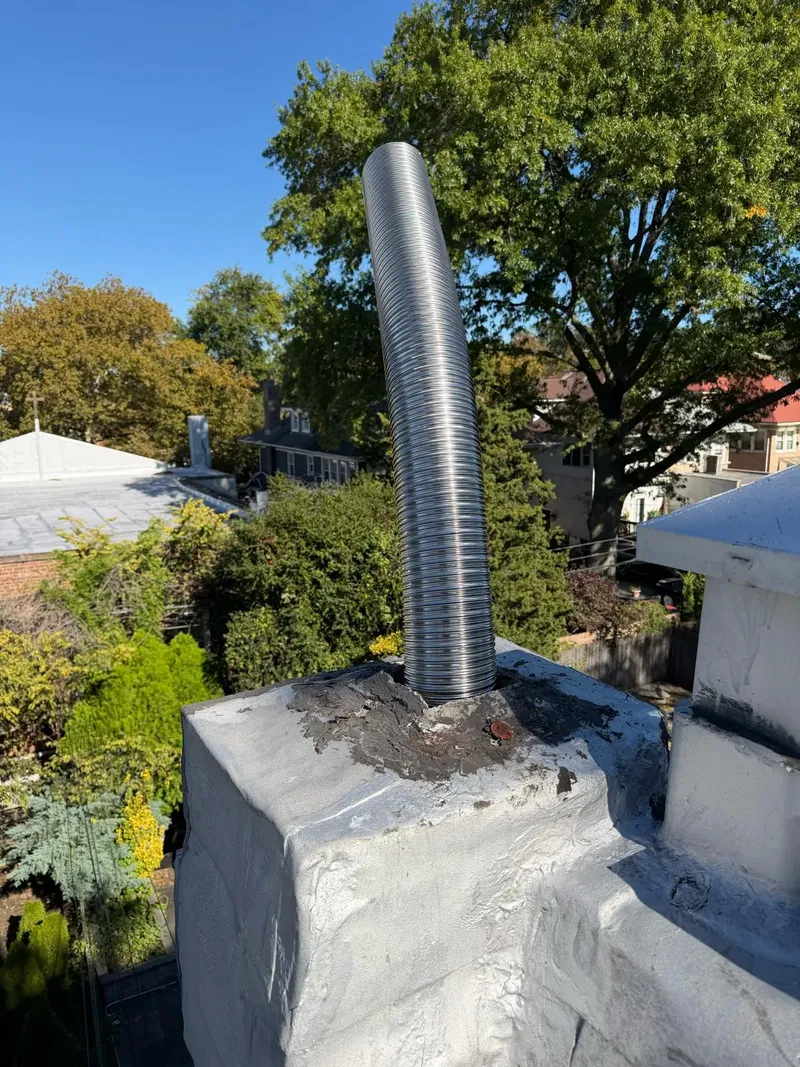 Stainless steel liner rising out of the top of a chimney
