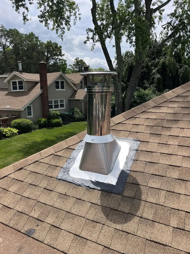 Metal chimney pipe through a shingle roof