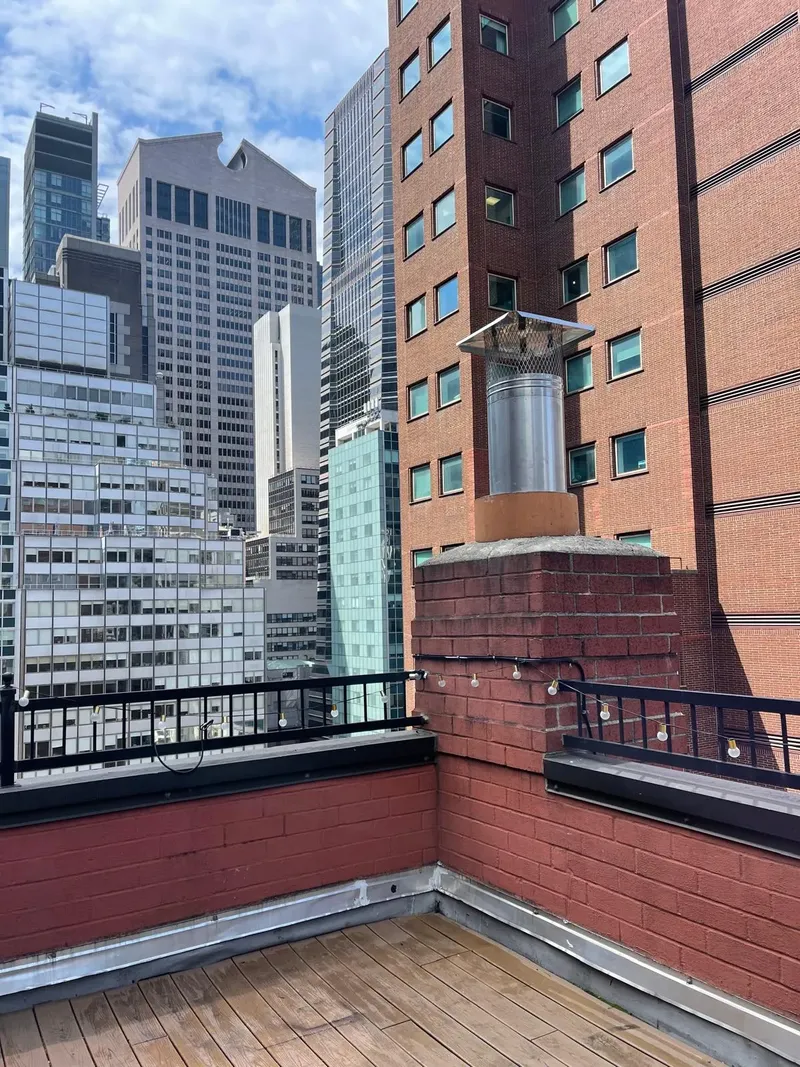 Rooftop chimney among high-rise buildings