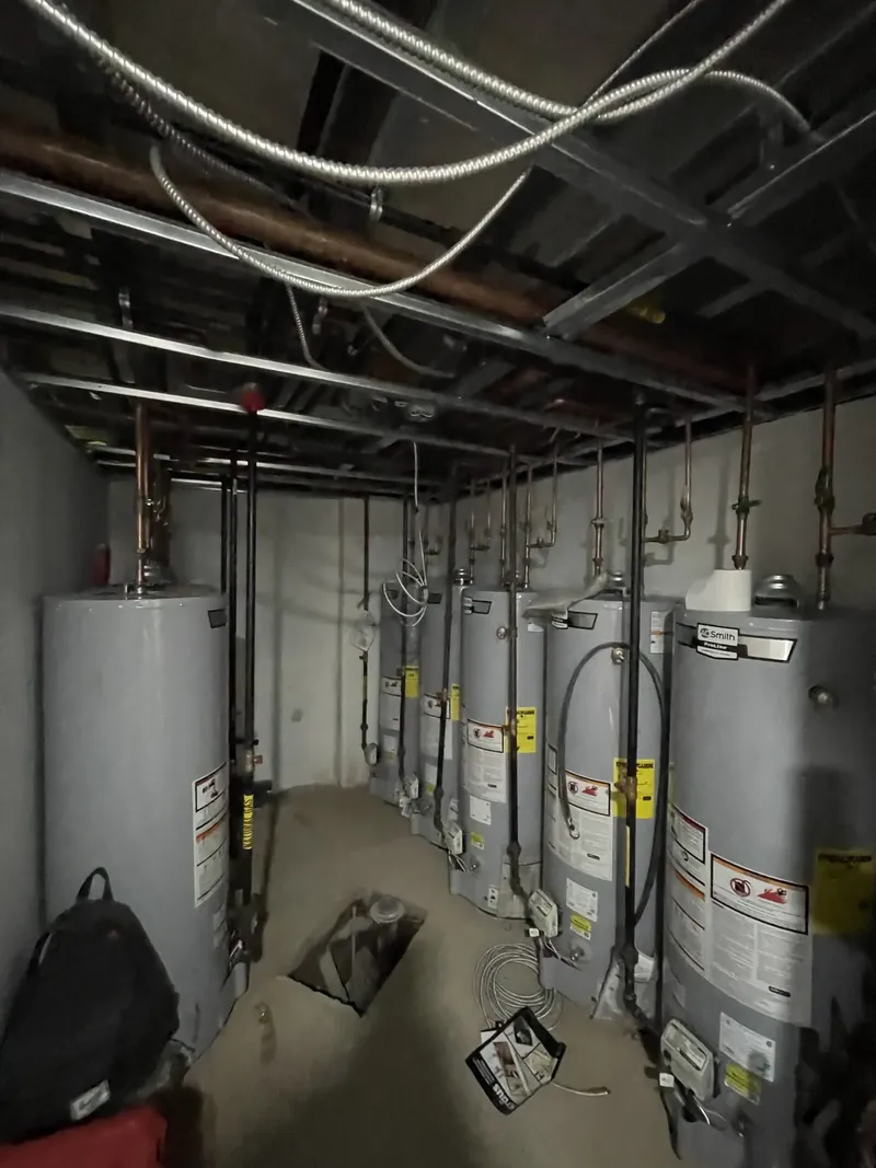 Gas water heaters and vent pipes in an apartment building basement